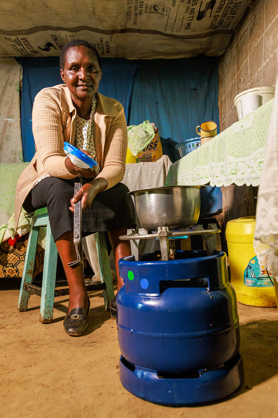 Bettering Human Lives Foundation Woman Cooking with Gas Stove